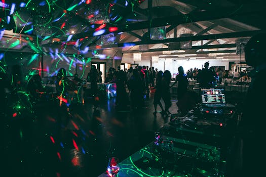 Vibrant nightclub scene with dancing crowd and DJ in Cambridge, Canada.